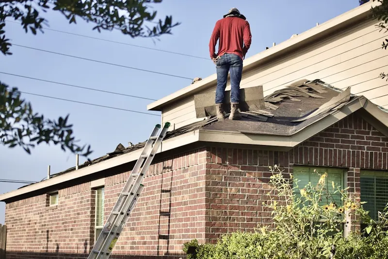 Professional roofer working on a residential roof in Locust Neck Heights